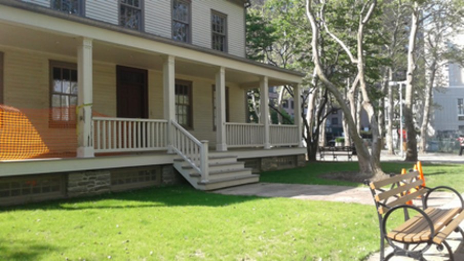 Blackwell House, a yellow clapboard farmhouse with a covered porch, on a lawn.