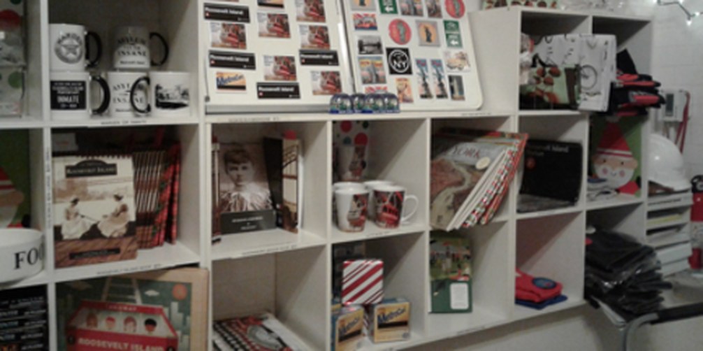 Shelves inside the Visitor Center kiosk stocked with books, mugs, magnets and island souvenirs.