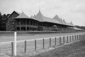 Warren-designed clubhouse with 2-story veranda and conical turrets in the foreground,